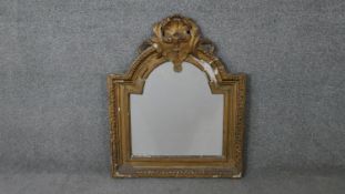 A 19th century carved giltwood and gesso arched wall mirror with shell and foliate cresting. H.79