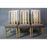 A set of six contemporary slat back light oak dining chairs with upholstered seats on square