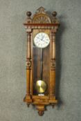 A late 19th century walnut cased Vienna regulator with Roman numerals on a white enamel dial. H.