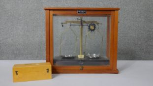 A Griffin & George Limited scientific scale, with chrome pans, in glazed case. With a boxed set of