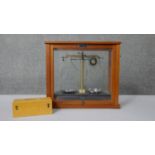 A Griffin & George Limited scientific scale, with chrome pans, in glazed case. With a boxed set of