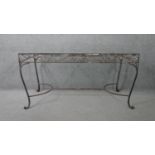 A vintage wrought iron garden or conservatory table with plate glass top. H.76 W.153 D.76cm