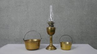 Two Victorian brass preserve saucepans and a Victorian brass oil lamp with glass funnel. H.63 Diam.