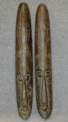 A pair of carved African masks. H.101cm