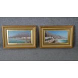 Two gilt framed oils on canvas of Continental coastal townscapes. With metal name plaques;