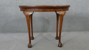 A mid century burr walnut Georgian style games table with lift up top revealing leather lined and