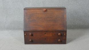 A Georgian country oak table top bureau with fall front enclosing a fitted interior. H.54 W.64 D.