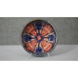 A Persian glazed ceramic bowl, the interior decorated with floral motifs, marked and dated to