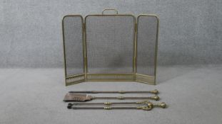A Victorian brass fire guard along with a set of brass fire irons. H.66 W.85cm (largest)