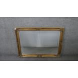 A gilt framed wall mirror with rectangular bevelled plate. H.75 W.105cm