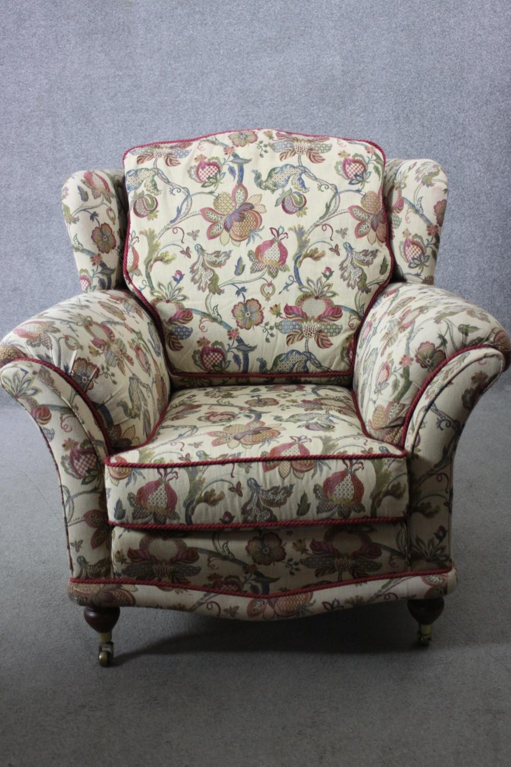 A 19th century armchair in floral tapestry style upholstery on turned mahogany supports