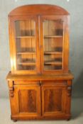 A late 19th century mahogany library bookcase with upper glazed section above drawers and panel