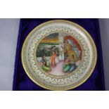 A blue velour cased Indo-Persian hand painted and gilded marble plate. Decorated with figures within