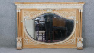 A 19th century pitch pine overmantel mirror with shaped bevelled plate flanked by Corinthian columns