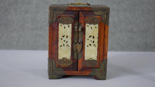 A vintage Chinese hardwood and brass travel jewellery box with pierced Jade panels to the doors