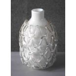 A white and clear Art Glass vase with open work netting design. Label verso. H.31 Diam.20cm.