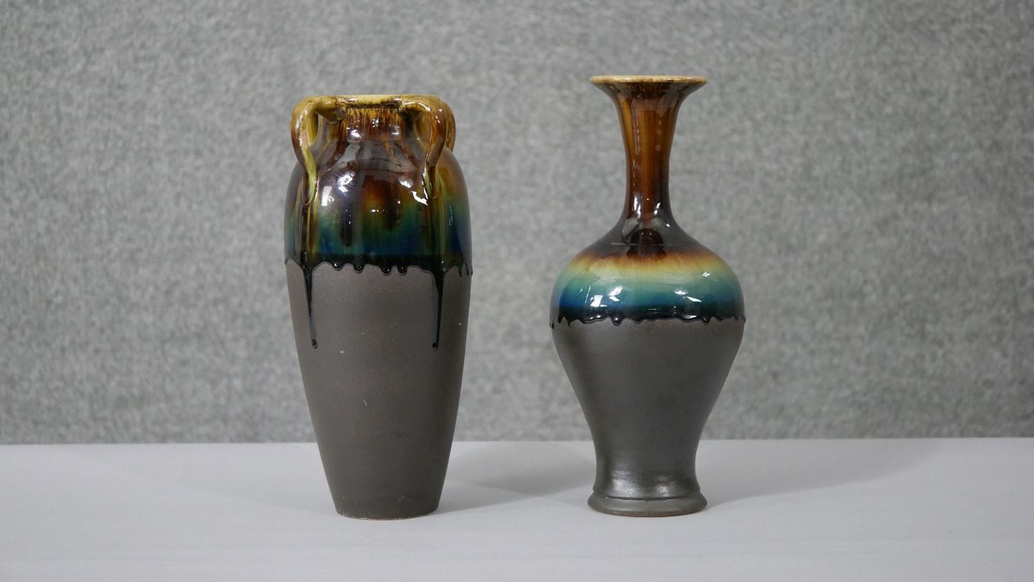 Two Persian honey and turquoise drip glazed ceramic vases one with four loop handles. H.29 W.12cm (