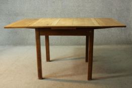 A mid century oak draw leaf dining table on square supports. H.76 W.153 (extended) D.91cm .