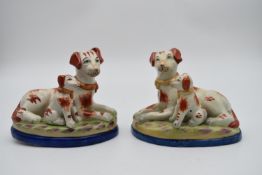 A pair of 19th century Staffordshire style tan and white dogs, mother and puppy. H.18 W.20cm
