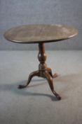 A Georgian mahogany tilt top table on baluster turned pedestal with tripod cabriole pad foot