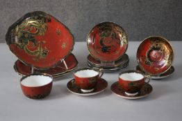 A part New Chelsea Staffordshire gilded hand painted bone china black dragon design on red ground