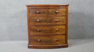 A Victorian figured mahogany bow fronted chest of drawers on plinth base. H.111 W.104 D.53cm
