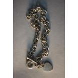 A Tiffany silver chain link necklace with heart pendant and T-bar, stamped Tiffany & Co.