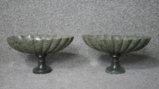 A pair of early 20th century carved green marble pedestal urns with gadrooned design. H.12 W.22 D.