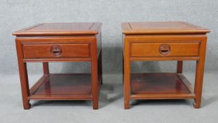 A pair of Chinese carved hardwood bedside or lamp tables, each fitted with frieze drawer on square