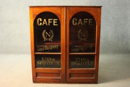 A late 19th century display cabinet with arched and glazed signwritten advertising doors. H.110 W.98