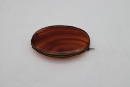 An antique Carnelian oval brooch with a secure pin to the reverse. L.7cm