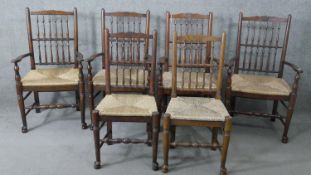 A set of six 19th century style oak spindle back dining chairs with woven seats on turned