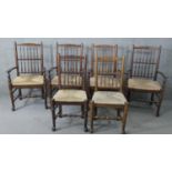 A set of six 19th century style oak spindle back dining chairs with woven seats on turned