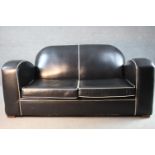 An Art Deco two seater sofa in piped leather upholstery on block supports. H.80 W.170 D.85 cm