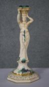 An early 20th century Sarreguemines pottery candlestick in the form of an Arab dancer. H.44 W.19 D.