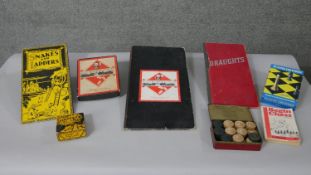 A collection of vintage board games. Including draught board and pieces, Snakes and Ladders,