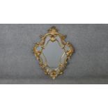 A carved giltwood Florentine style wall mirror. H.73 W.52cm