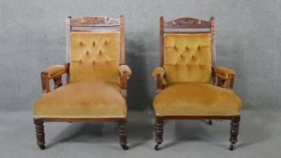 A pair of Victorian carved walnut armchairs in buttoned upholstery on turned tapering supports.