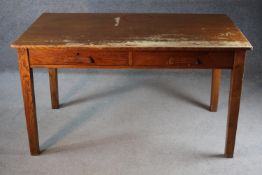 A mid century oak two drawer writing table on square tapering supports. H.76 W.177 D.82 cm.