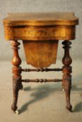 A Victorian burr walnut fold over top games and work table with inlaid chess and backgammon boards