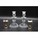 A pair of 20th century Baccarat cut crystal candle holders, along with a pair of silver plated