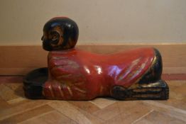 An Eastern carved and painted polychrome figure. H.36 W.64 D.24cm