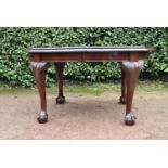 A C.1900 mahogany Georgian style dining table with wind out mechanism on carved cabriole ball and