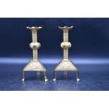 A pair of 20th century brass candlesticks, decorated with inlaid foliate and crisscross design to