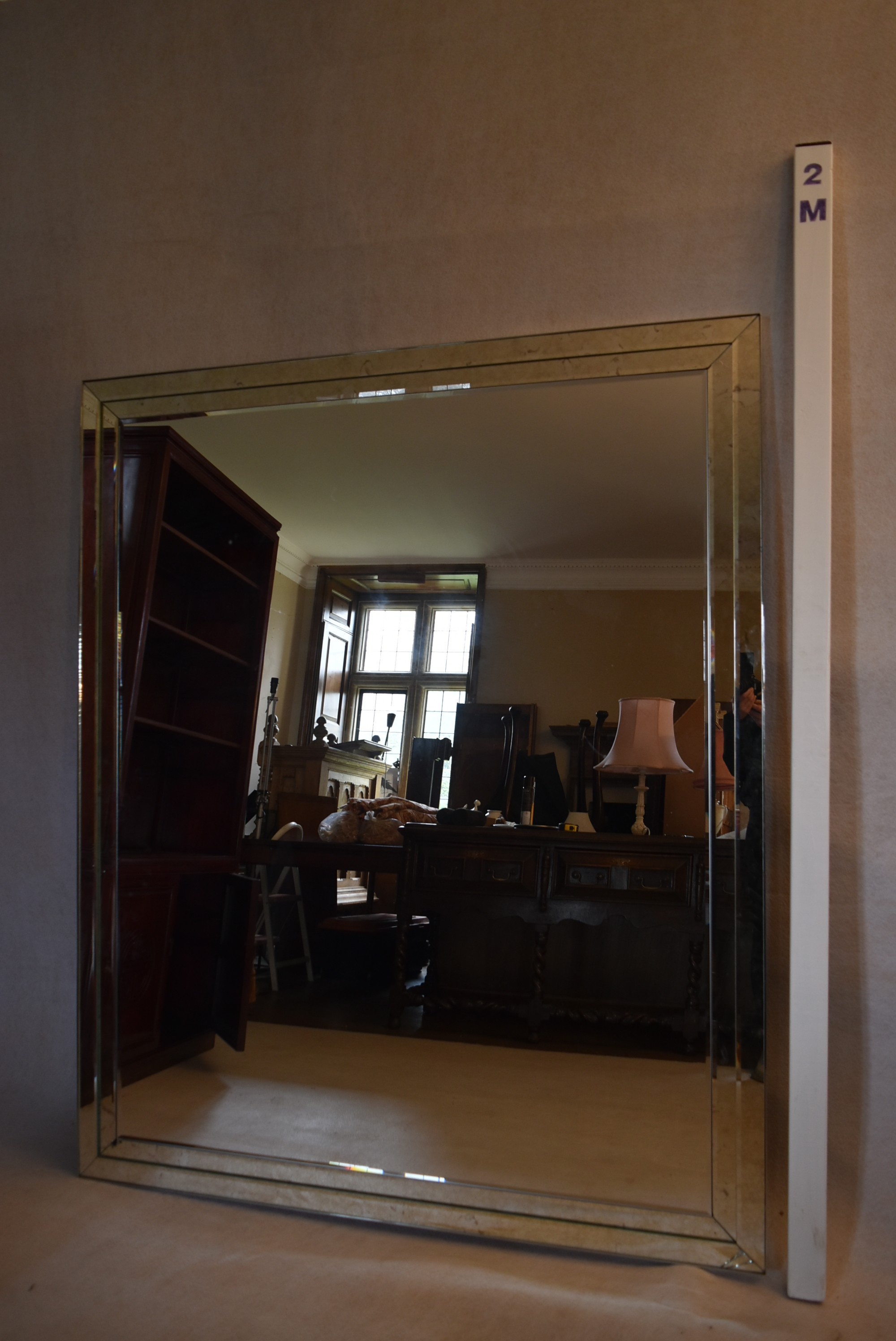 A large wall mirror in bevelled and glazed frame. H.142 W.170cm (some damage as photographed) - Image 6 of 6