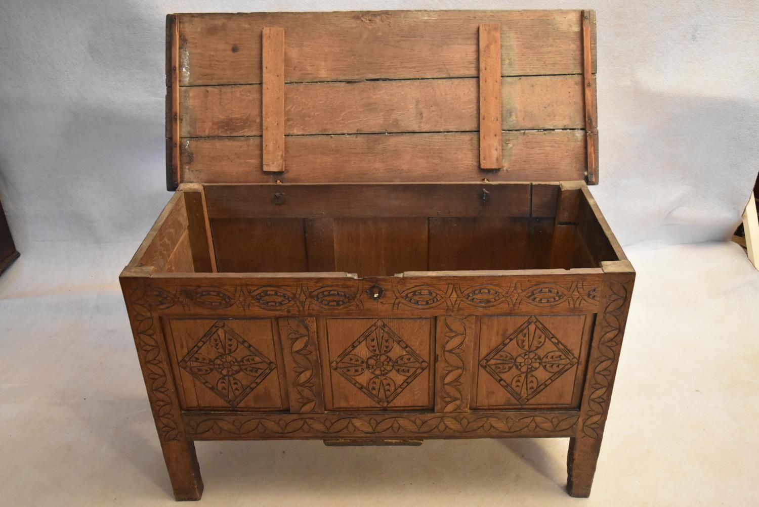 An 18th century country oak coffer with its original hinges and lozenge carved panels raised on - Image 6 of 10
