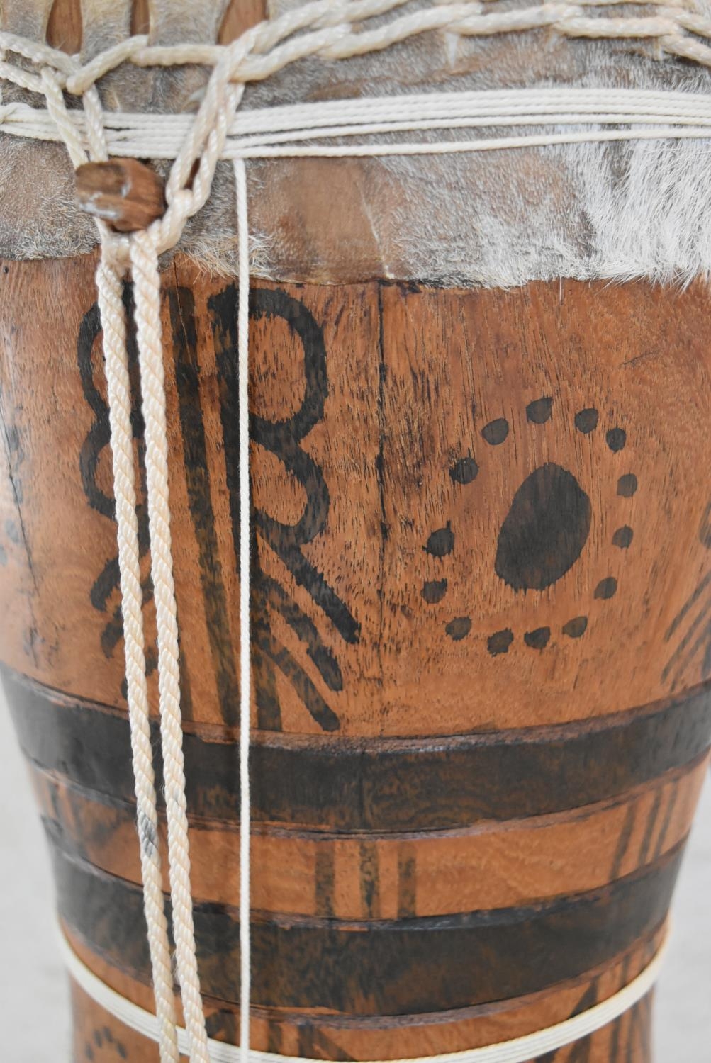 A Senegalese painted hardwood tribal drum. H.44 W.25cm - Image 3 of 6