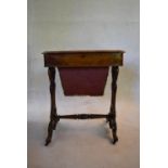 A mid Victorian burr walnut sewing table with floral inlay to the inside of the hinged lid and