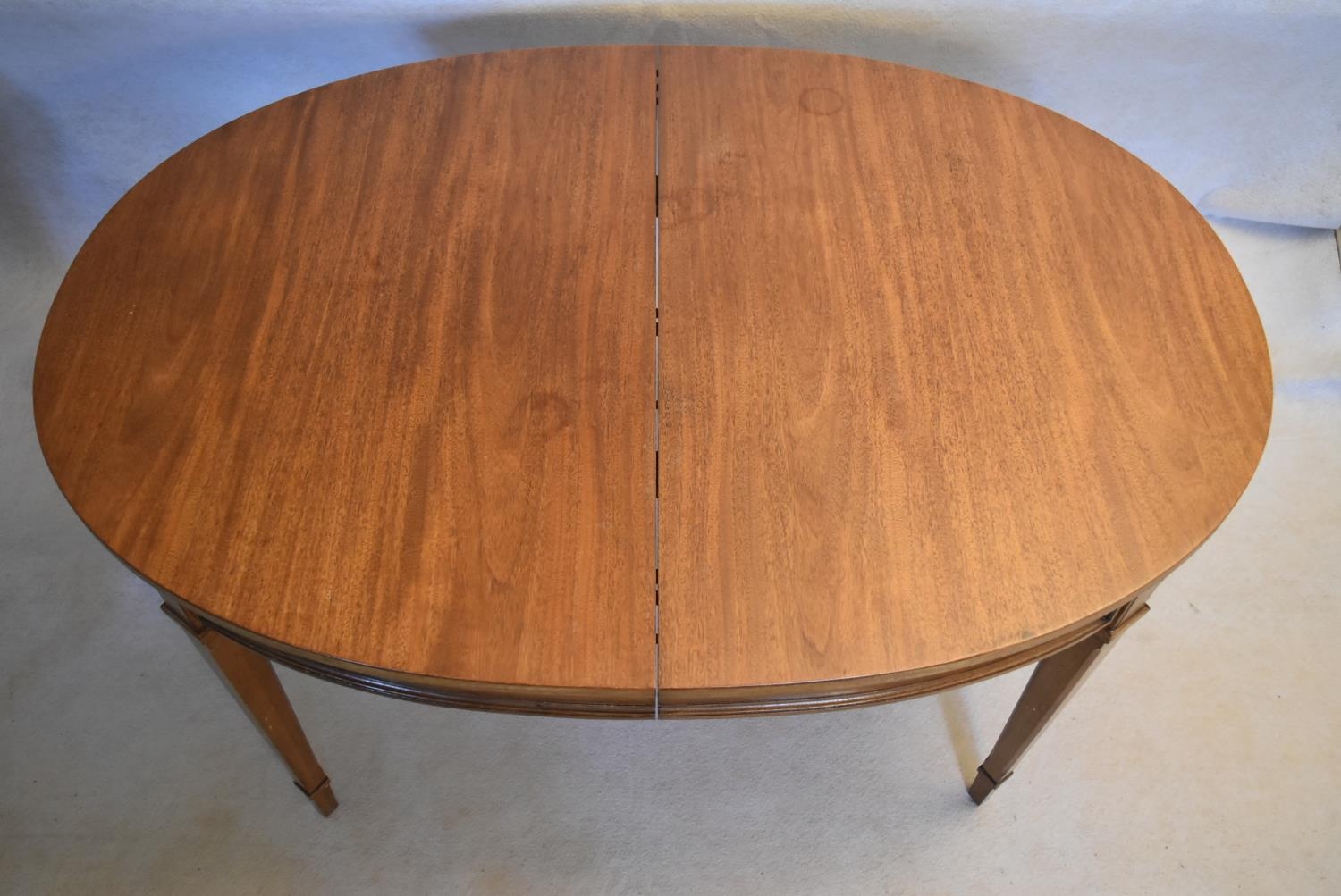 A walnut extending dining table with three extra leaves raised on square tapering supports. H.73 W. - Image 3 of 11