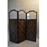 A 19th century mahogany framed two fold, three panel screen with shaped bevelled glass upper